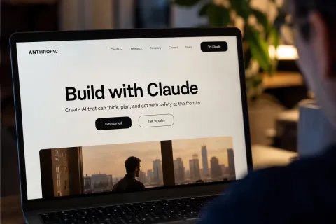 Laptop displaying Anthropic’s Claude AI website in a realistic office setting, illustrating Anthropic's financial results and the company’s business growth in 2026.