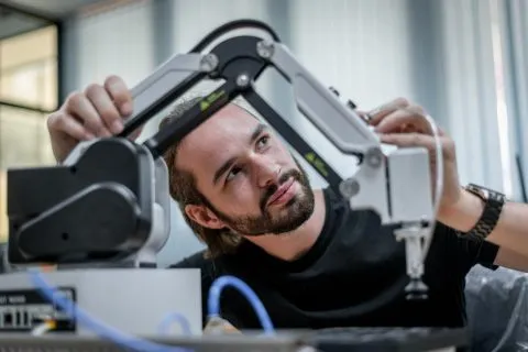 Causal AI in robotics showing an intelligent robotic arm handling objects in a research laboratory, demonstrating cause-and-effect reasoning and autonomous decision-making.
