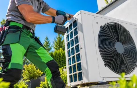 Technician installing an outdoor cooling unit, illustrating Pascal solid-state cooling